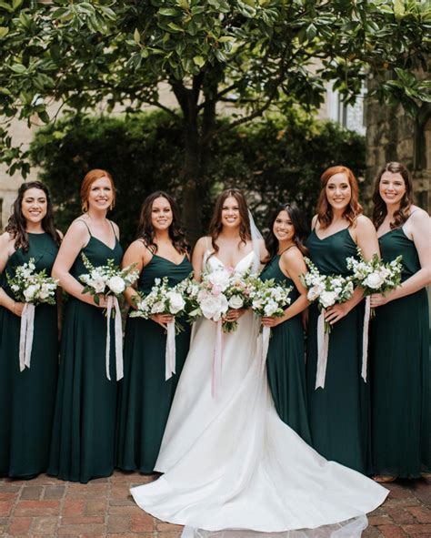 A Group Of Women Standing Next To Each Other Wearing Green Dresses And