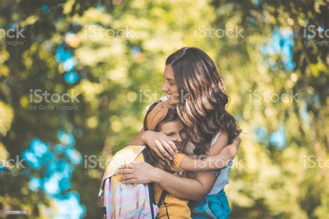 Mother Hugging Her Daughter And Standing In Nature Hug Of Love Stock