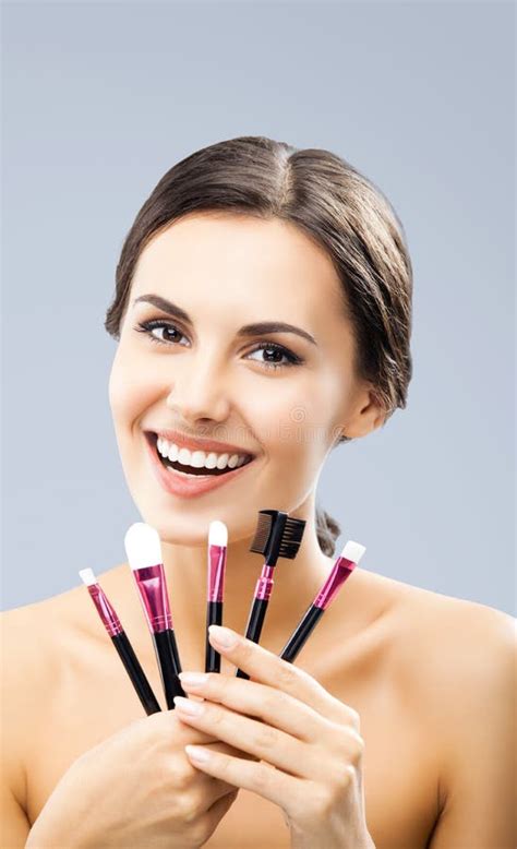 Beautiful Woman Holding In Hands Showing Giving Cosmetics Brushes