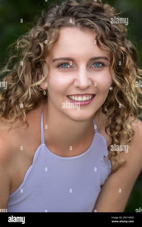 Head And Shoulders Portrait Of A Smiling Young Caucasian Woman With