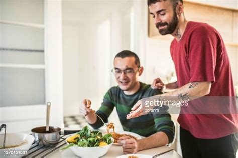 Gay Couple Eating Dinner At Home Photos And Premium High Res Pictures