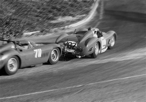 Two Race Cars Racing On The Track In Black And White Photo One Is