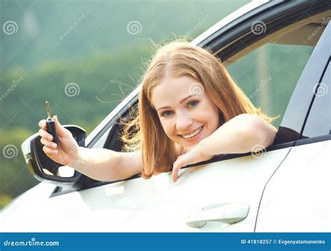 Woman Driver Happy Showing Thumbs Up Coming Out Of Car Window Stock