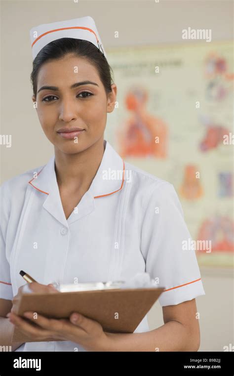 Female Nurse Writing On A Clipboard Stock Photo Alamy
