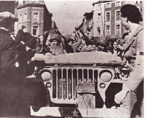 An Old Black And White Photo Of People In The Back Of A Jeep