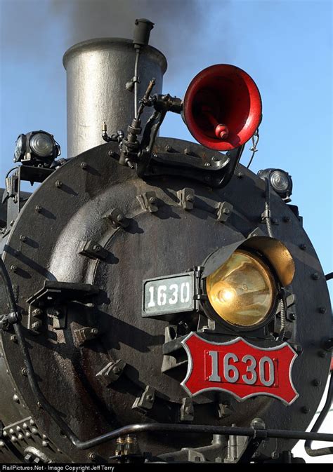 An Old Fashioned Steam Engine With Its Lights On