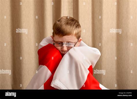 A Sad Looking 12 Year Old Boy With The England Flag Draped Round His