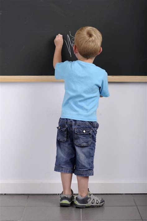 Little Boy Writing On A Blackboard Royalty Free Stock Images Image