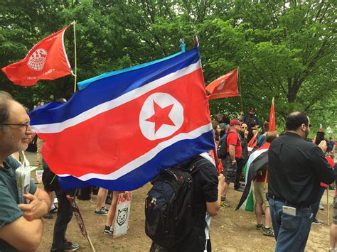 Does it consider itself communist, and if it isn't, then what is it? North Korea Flag at Antifa Rally on May Day 2017 : OfficialDP