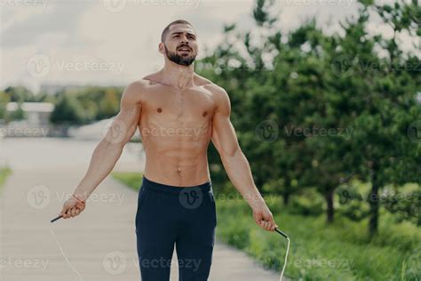 Athletic Motivated Man With Naked Torso Concentrated On Intense Fitness Training Program Jumps