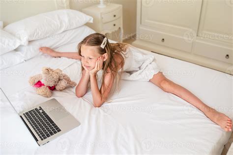 Cute Little Girl Doing Homework On Laptop 17704307 Stock Photo At Vecteezy
