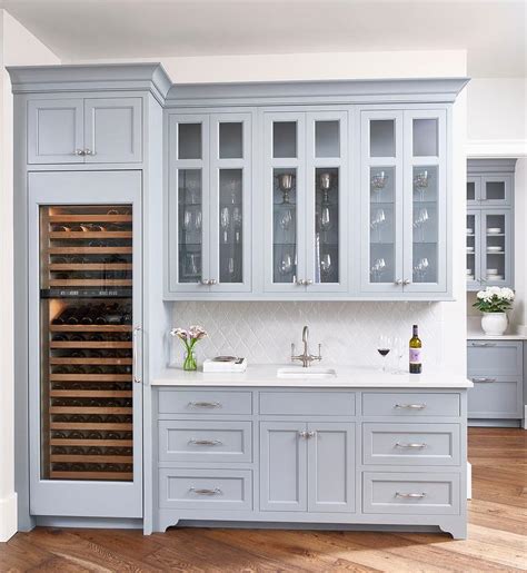 One small upper and one larger upper. Blue Gray Butler Pantry Cabinets with Light Gay Arabesque Tiles - Transitional - Kitchen