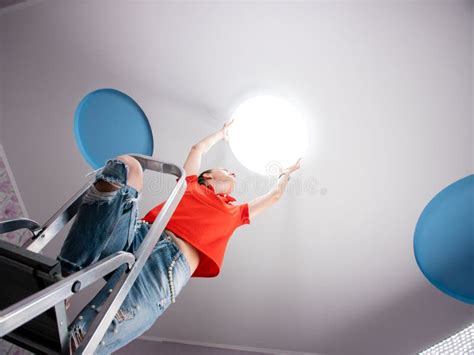 The Woman In The Room Sets The Led Ceiling Light Stock Photo Image