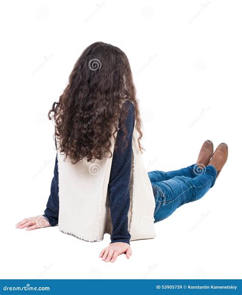 Back View Beautiful Curly Woman Sitting On Floor And Looks Into Stock