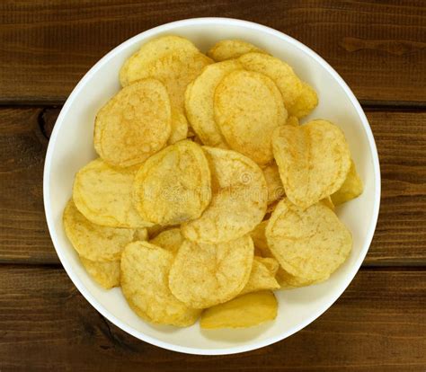 Potato Chips In Bowl On A Wooden Background Top View Stock Image