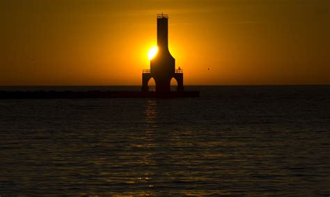 Sun Behind The Lighthouse At Port Washington Wisconsin Image Free