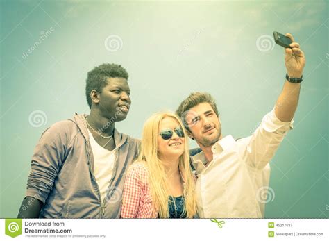 Group Of Multiracial Happy Best Friends Taking A Vintage Selfie Stock