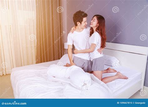Happy Young Attractive Couple Hugging On Bed In Bedroom Stock Image Image Of Beautiful Adult