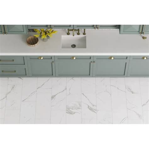 A Bathroom Sink Sitting Under A Mirror Next To A White Counter Top With