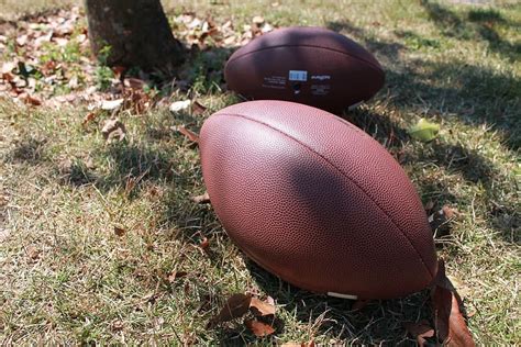 Hd Wallpaper Two Brown Football Balls On Ground During Daytime