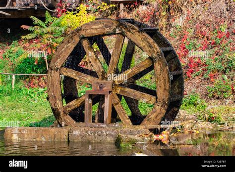 Working Watermill Wheel With Falling Water In The Village Stock Photo