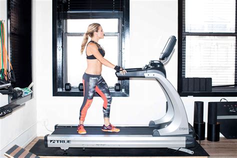 a woman is running on a treadmill