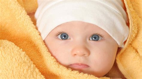 Download Baby Boy Wrapped In Yellow Towel Wallpaper