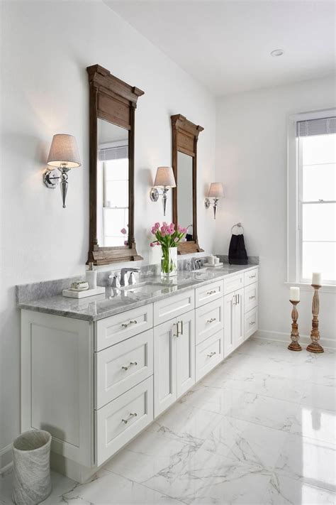 This Traditional White Master Bathroom Features White Shaker Style