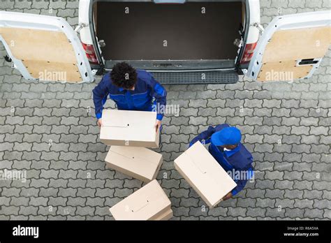Delivery Men Unloading The Cardboard Boxes Stock Photo Alamy