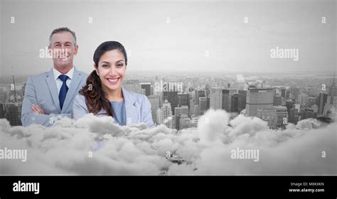 Business Man And Woman Facing Out With City Skyline Behind Them And