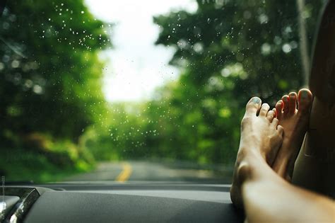 Womans Feet On The Dashboard Of A Car During A Road Trip By Stocksy