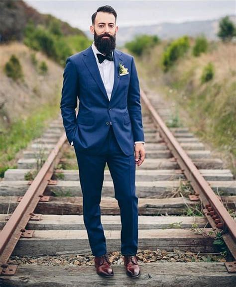Crisp slim navy suit with brown cap toe shoes brown leather belt light blue shirt white cotton pocket square lapel pin #businesscasual #suit however, when done right, a blue suit and brown shoe combination can look just as sharp and even more sartorial than any suit and black shoe ensemble. Image result for navy blue suit wedding | Blue suit ...