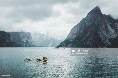 Group Of People Kayaking Near Reine Moskenes Lofoten Islands Norway
