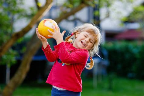 Little Adorable Toddler Girl Playing With Ball Outdoors Happy Smiling