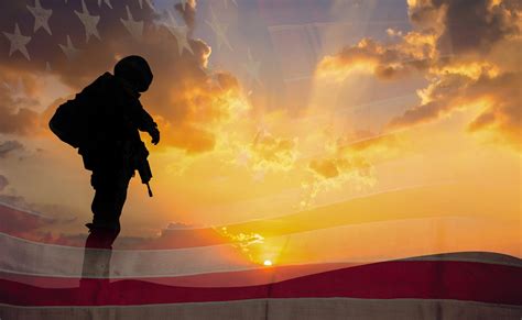 Double Exposure Silhouette Of Soldier On The United States Flag In
