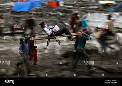 In This Picture Taken Thursday July 28 2011 A Hindu Pilgrim Is Carried By Porters On His Way