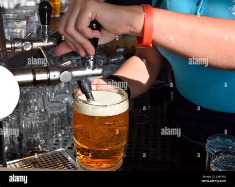 Bartender Pouring A Draft Beer From Tap Stock Photo Alamy