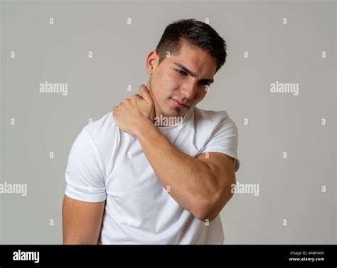Young Muscular Fitness Man Touching And Grabbing His Neck And Upper