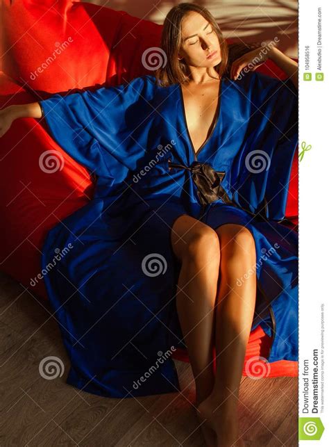 Beautiful Girl In Blue Silk Robe Resting In The Sunlight Stock Photo