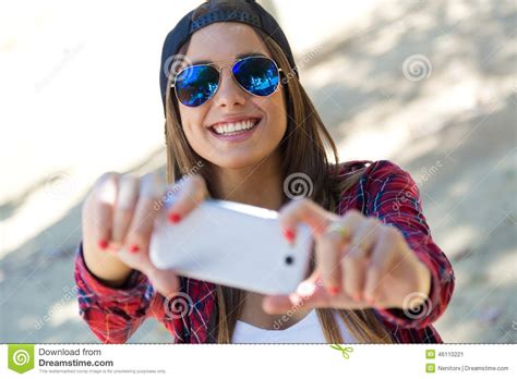 portrait of beautiful girl taking a selfie with mobile phone stock image image of nature