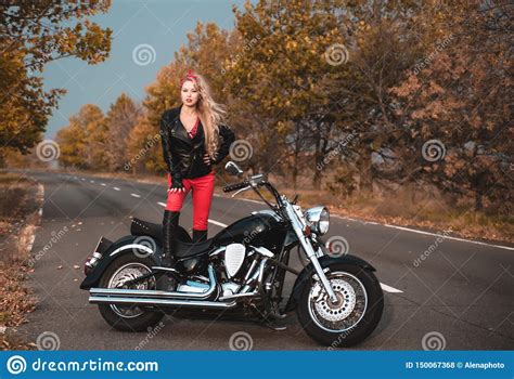 Beautiful Biker Woman Posing With Motorcycle Outdoors Stock Photo