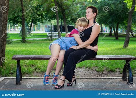 Mother And Daughter Sitting On A Bench In The Park Stock Image Image