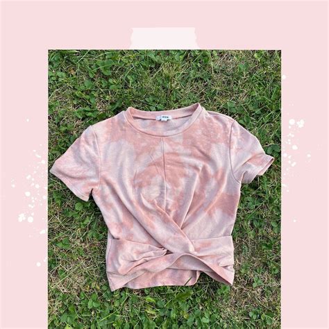 A Pink Shirt Laying On Top Of Grass
