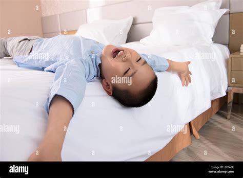 Boy Relaxing In Bed Stock Photo Alamy