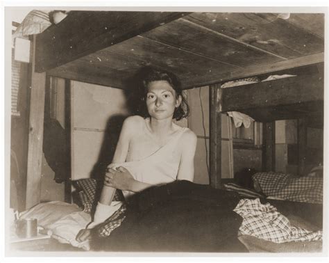 An Emaciated Female Jewish Survivor Of A Death March Sits Up In Bed At