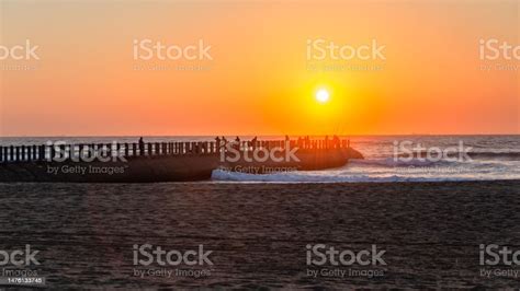 Fishing Silhouettes Beach Jetty Scenic Ocean Sunrise Stock Photo