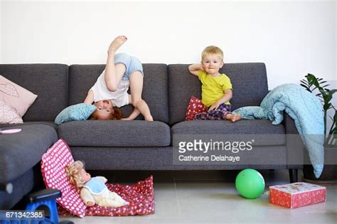 A Brother And His Sister Playing On A Sofa Photo Getty Images