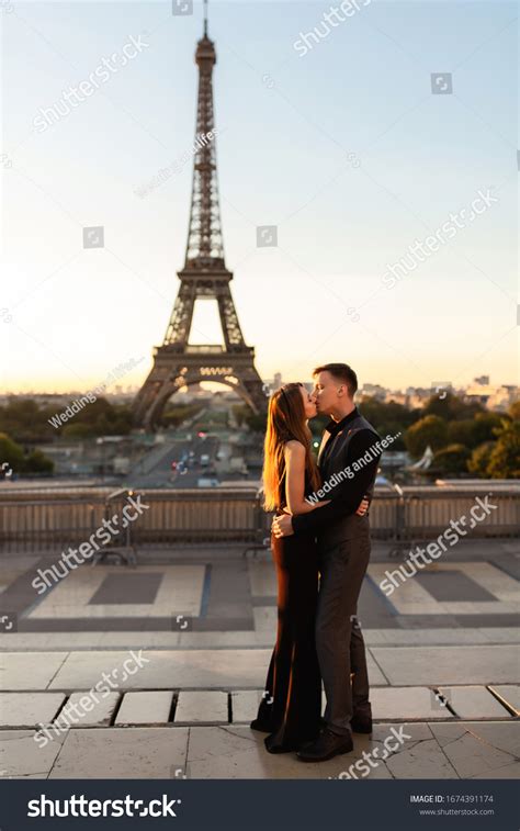 Romantic Couple Kisses Near Eiffel Tower Stock Photo 1674391174