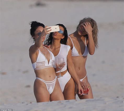 kim kardashian shows off her impressive assets in wet shirt as she frolics on beach in mexico