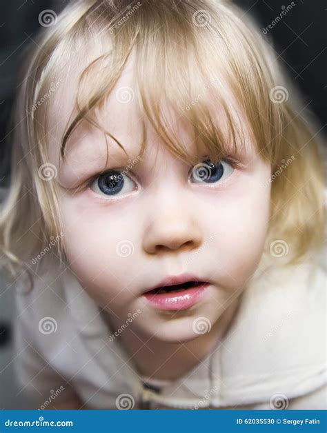 Beautiful Little Girl The Blonde With Huge Blue Eyes Looking Up Stock